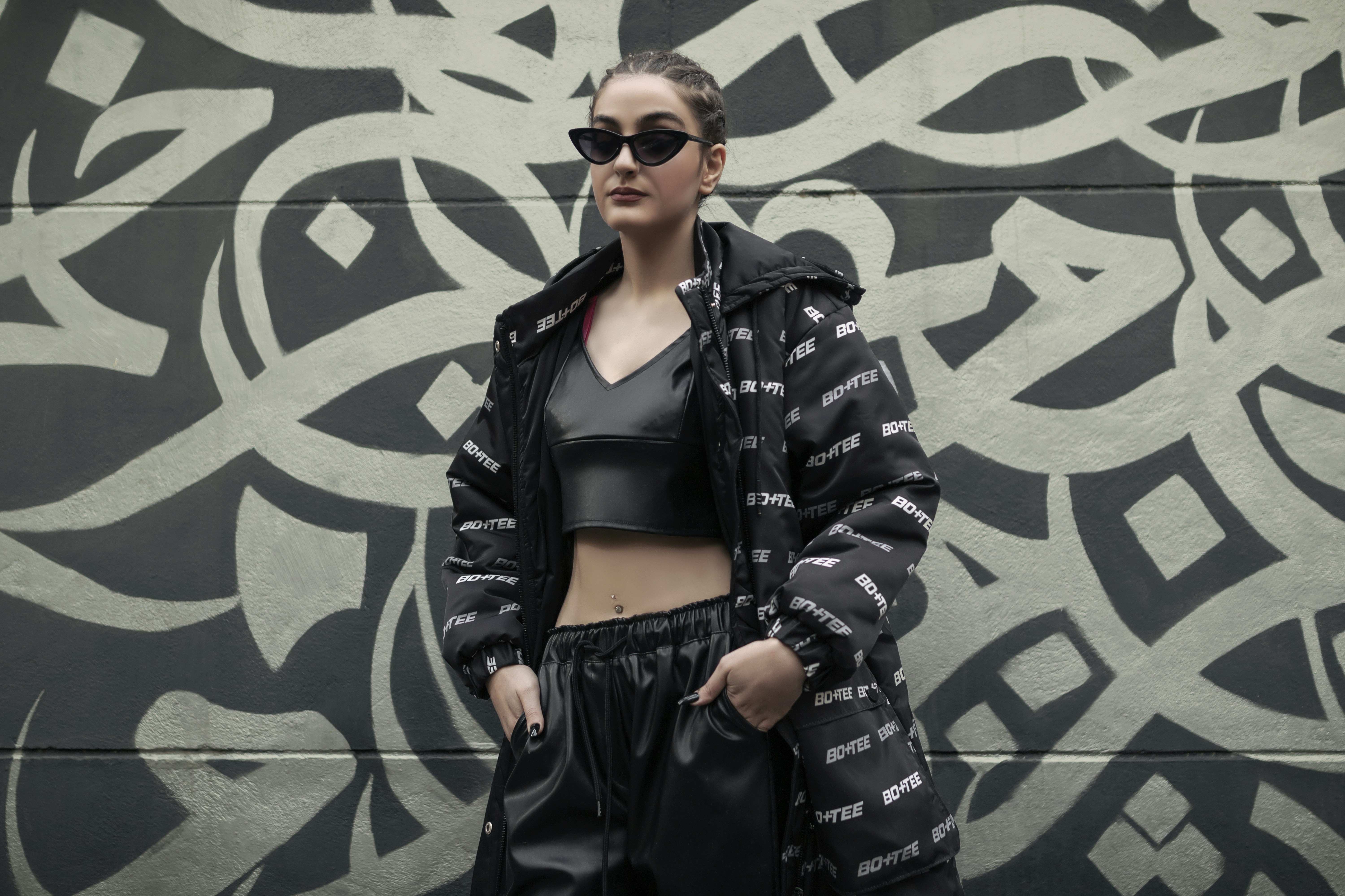 a woman standing in front of a wall