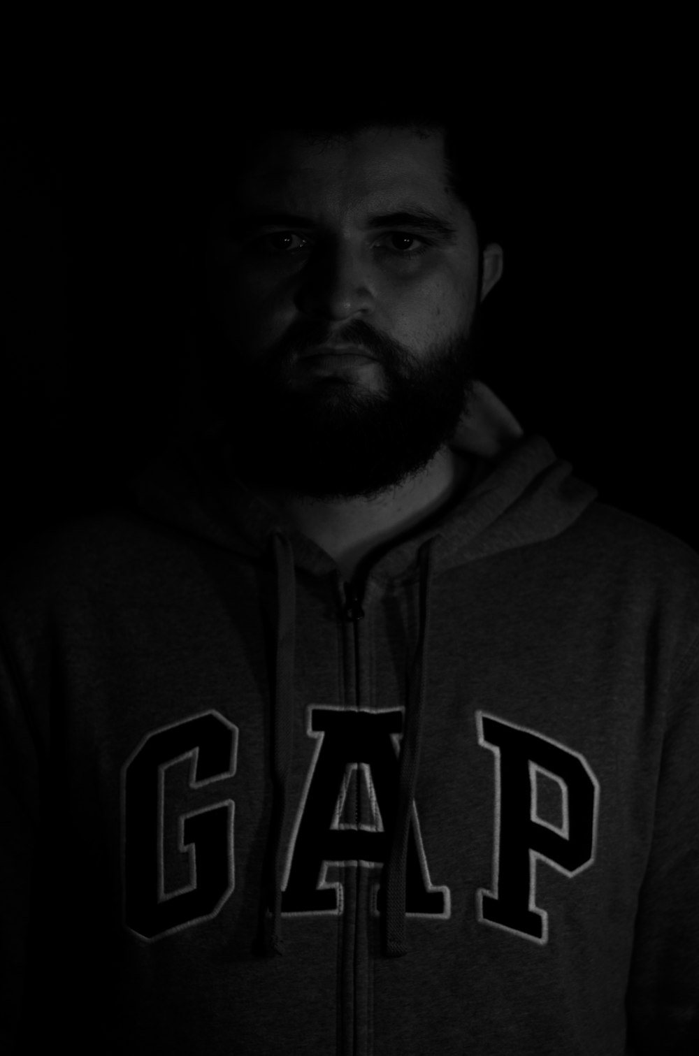 a man with a beard wearing a hoodie