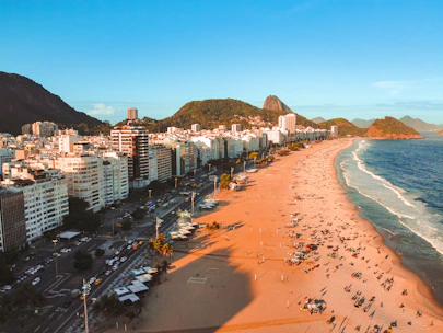 an aerial view of a beach with a city in the background