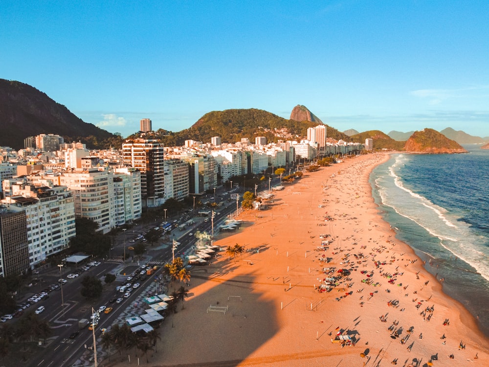 an aerial view of a beach with a city in the background