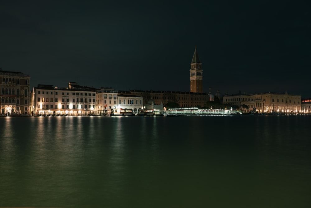 a large body of water with a clock tower in the background