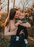 a woman holding a baby in her arms