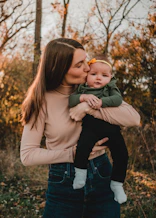 a woman holding a baby in her arms