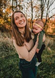 a woman holding a baby in her arms