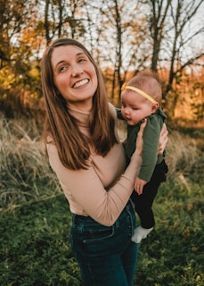 a woman holding a baby in her arms
