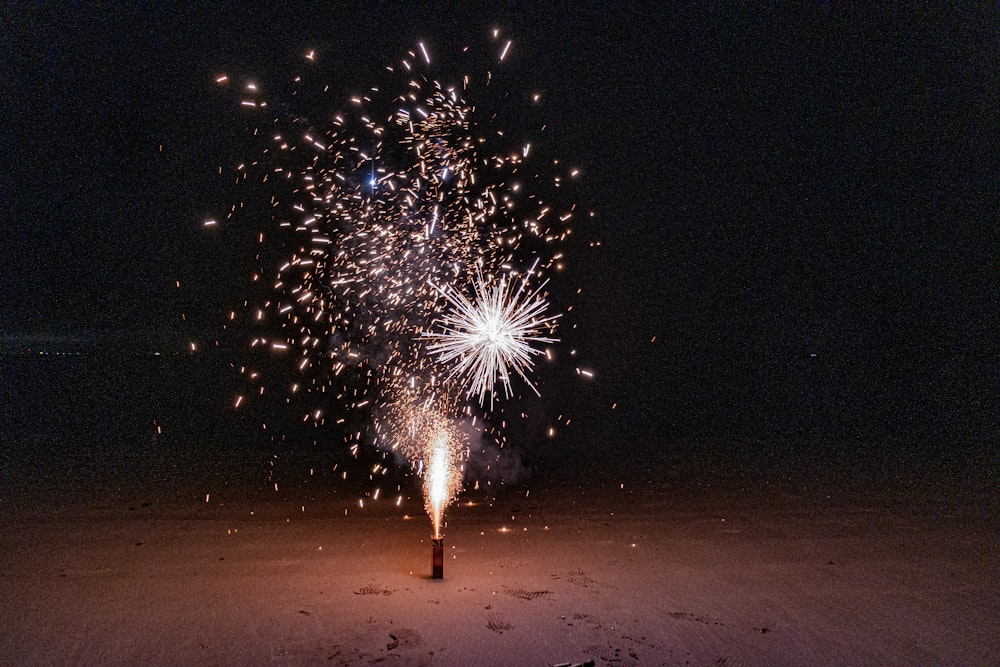 a fireworks is lit up in the night sky