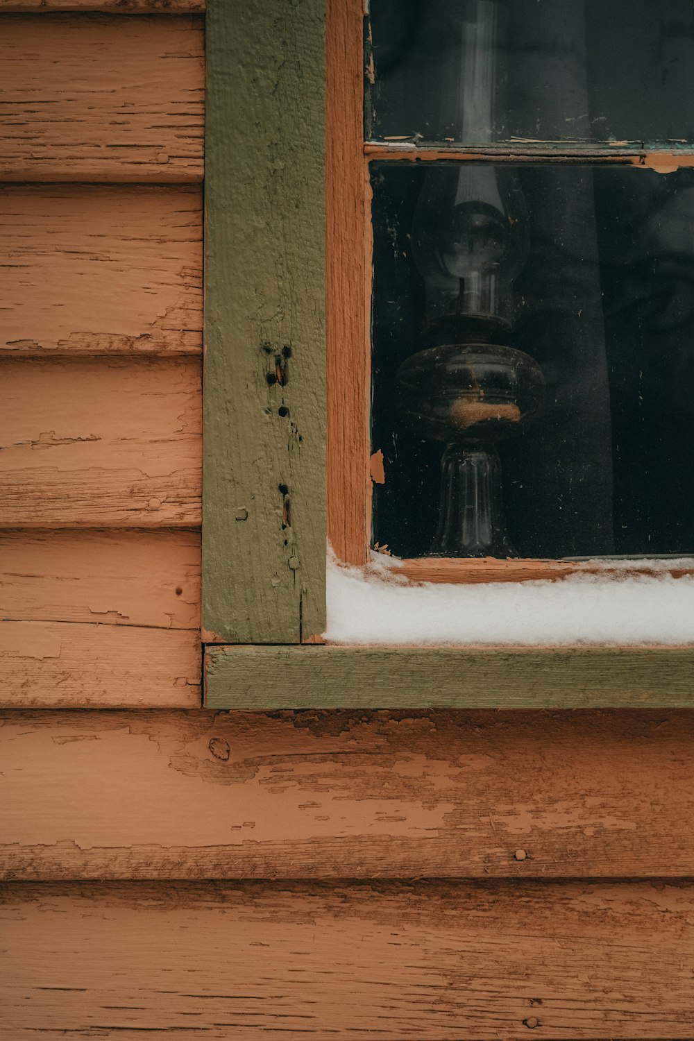 a close up of a window with snow on the window sill