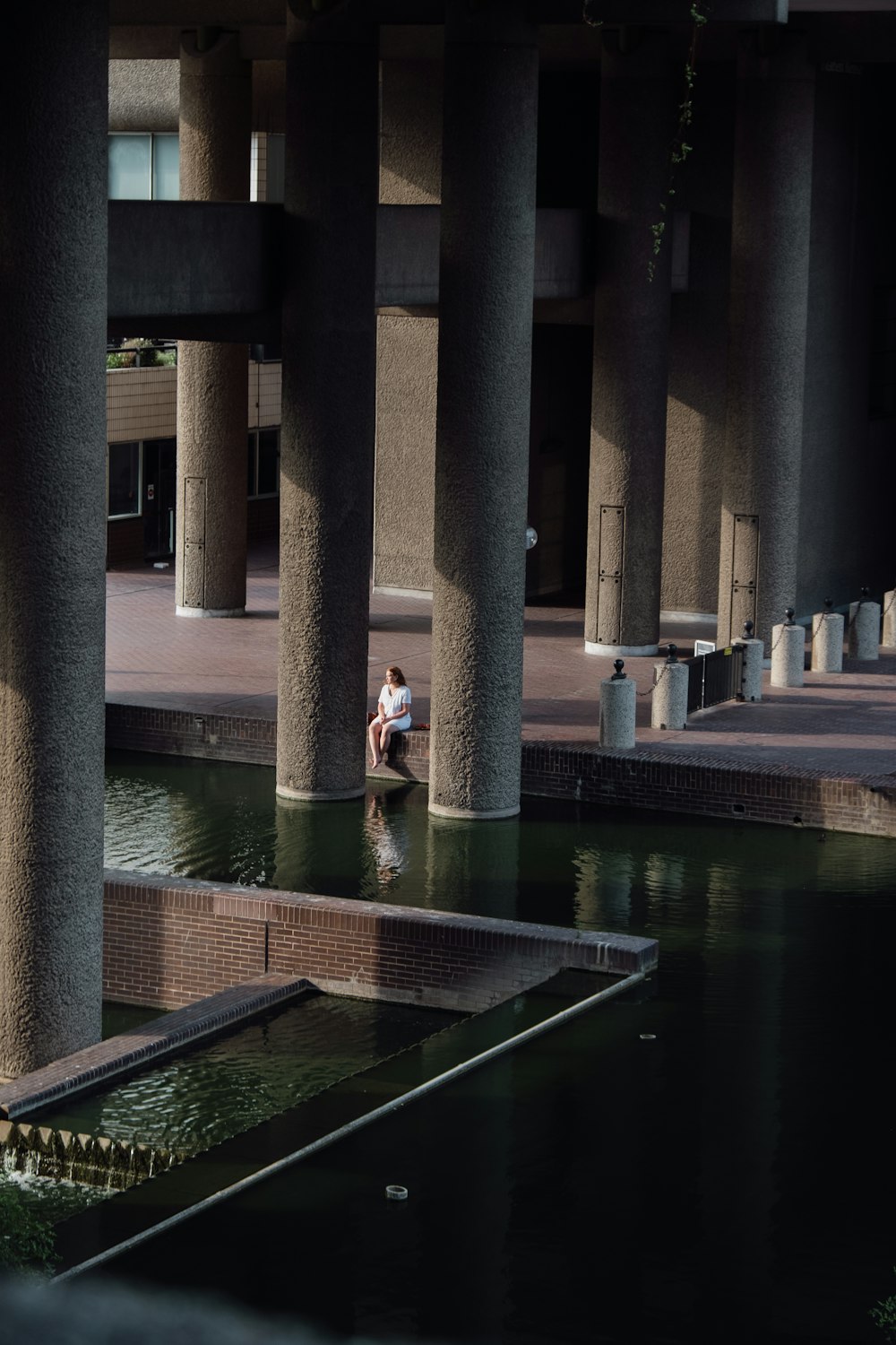 a person sitting on a bench in a body of water