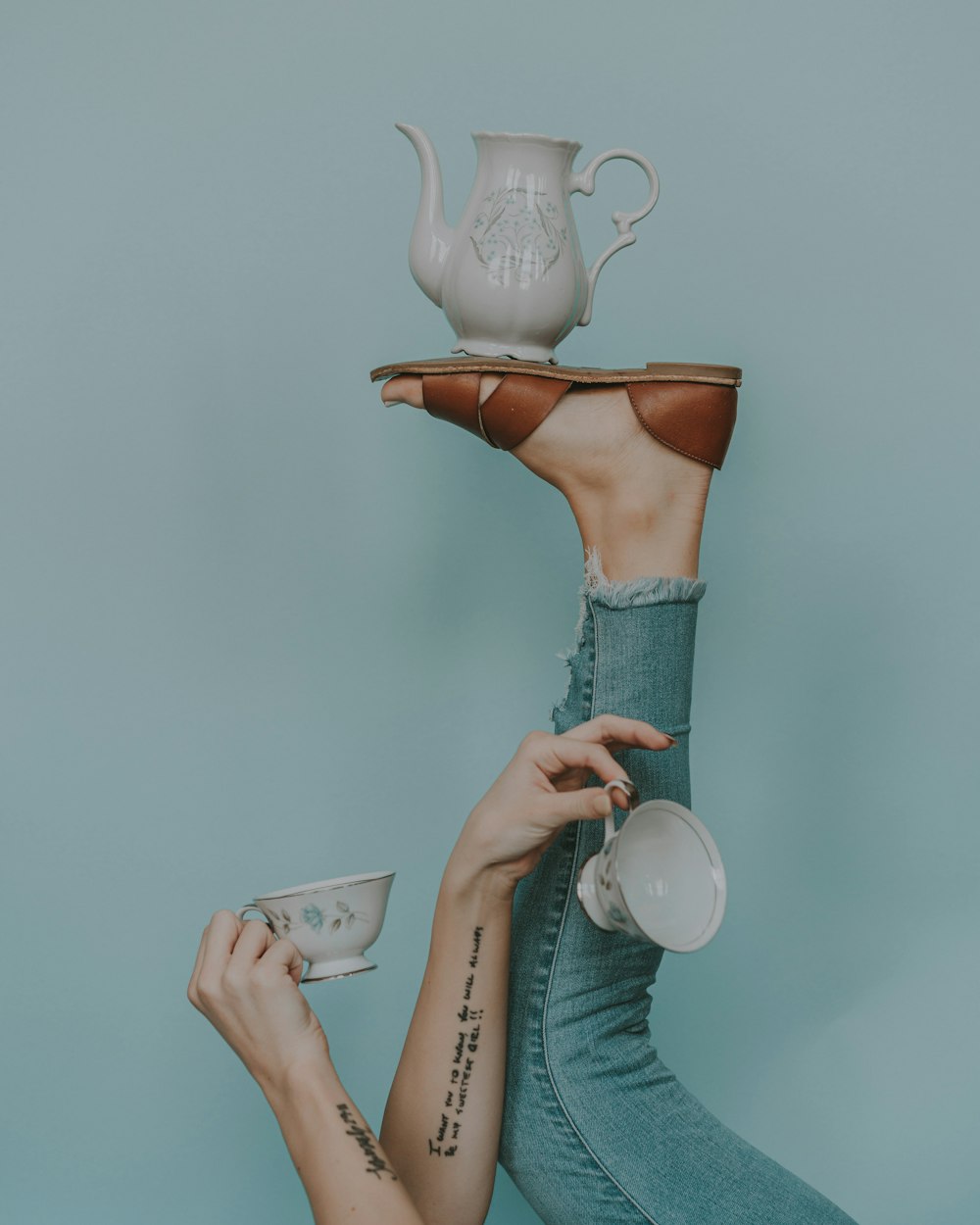 a woman holding a cup and saucer in her hands