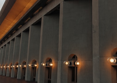 a row of lights that are on the side of a building