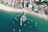 an aerial view of a beach with boats in the water