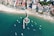 an aerial view of a beach with boats in the water