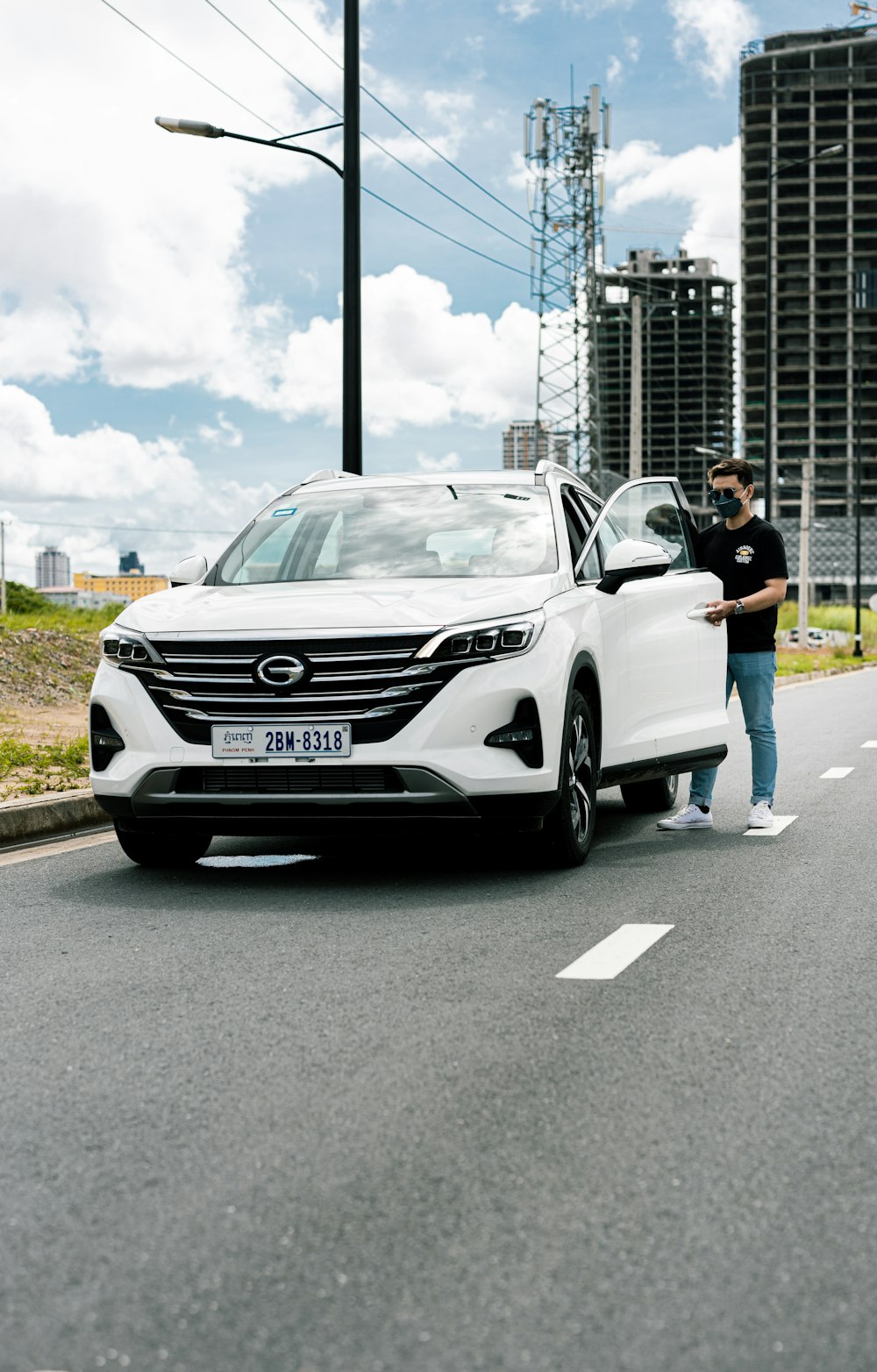 a man standing next to a white car