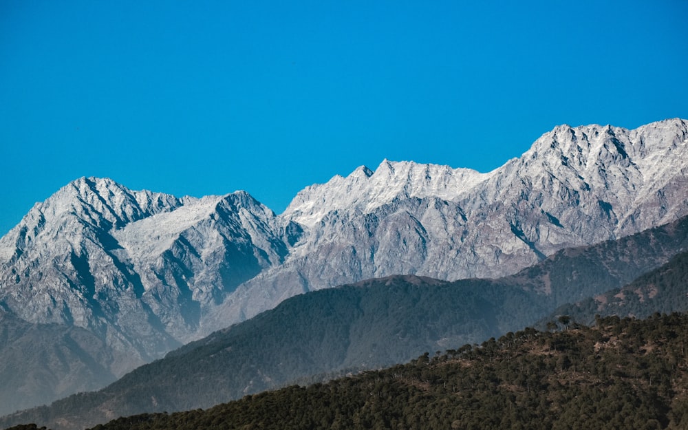 a view of a mountain range with snow on it