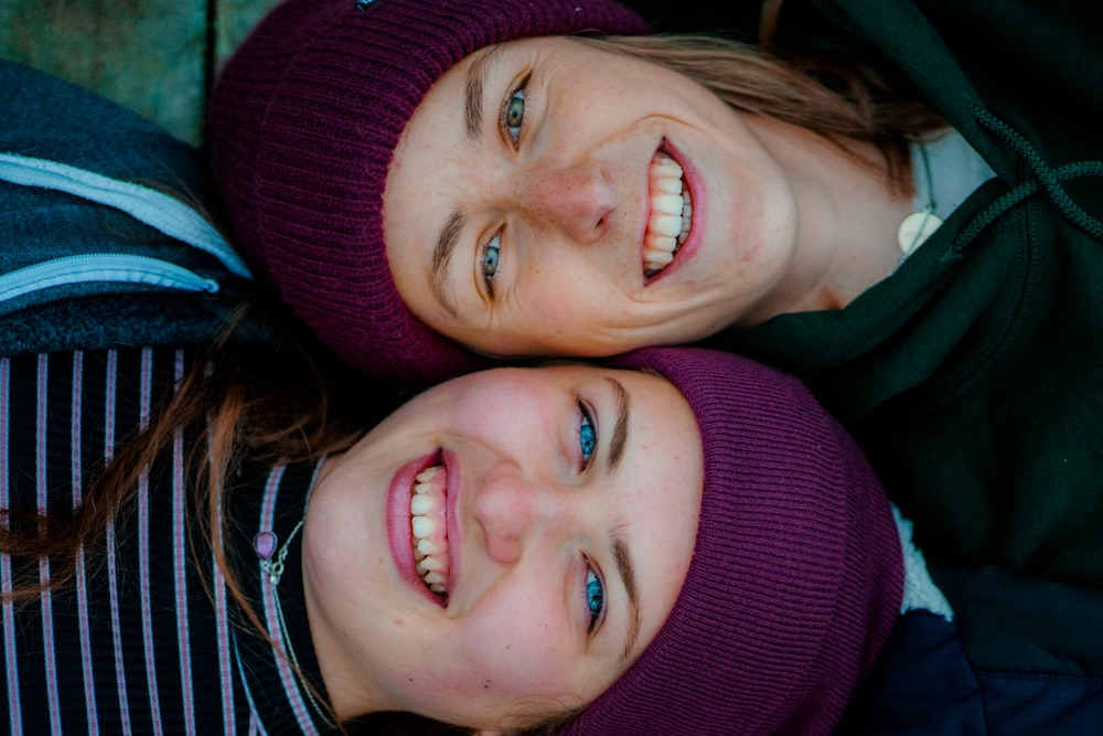 a couple of young girls laying next to each other