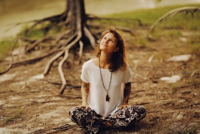 a woman sitting on the ground with her eyes closed