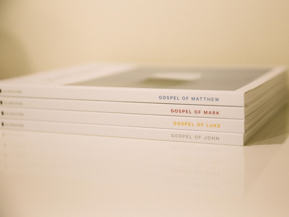 a stack of books sitting on top of a white table