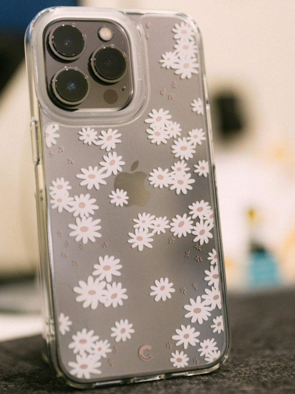 a clear case with white flowers on it