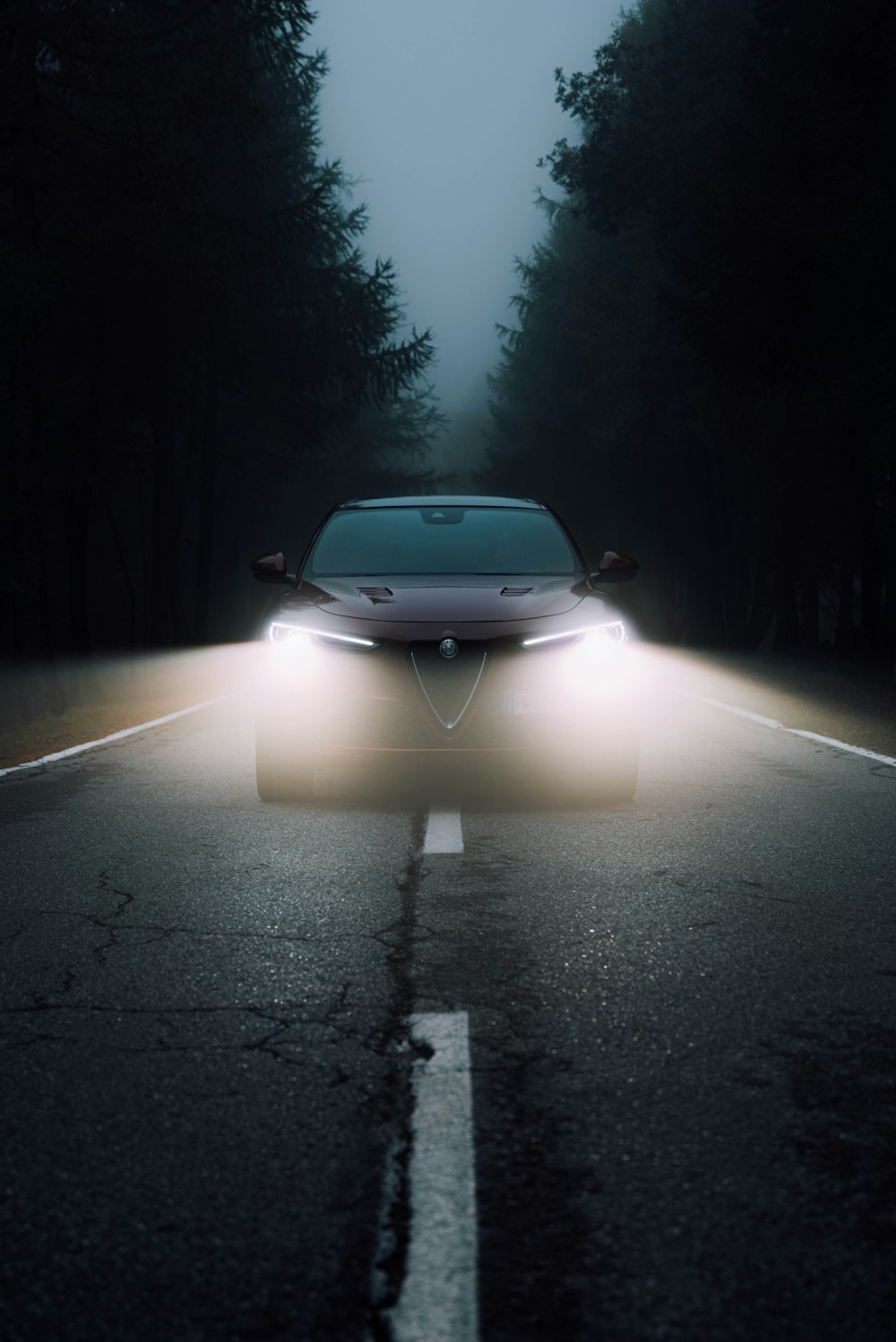 a car driving down a road at night