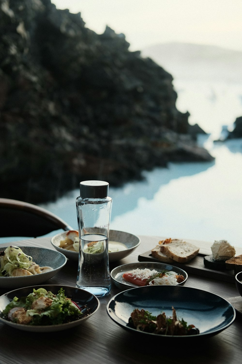 a wooden table topped with plates of food