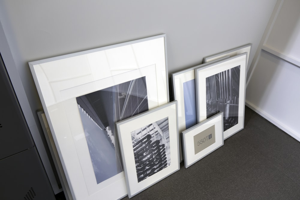a group of three framed pictures sitting next to each other