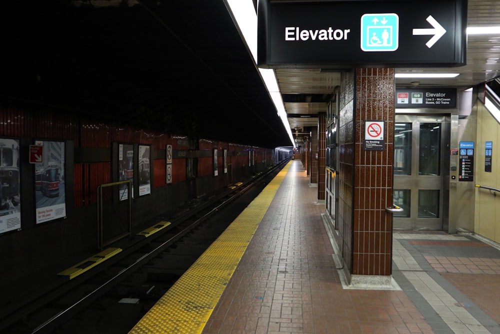 a train station with a train pulling into the station