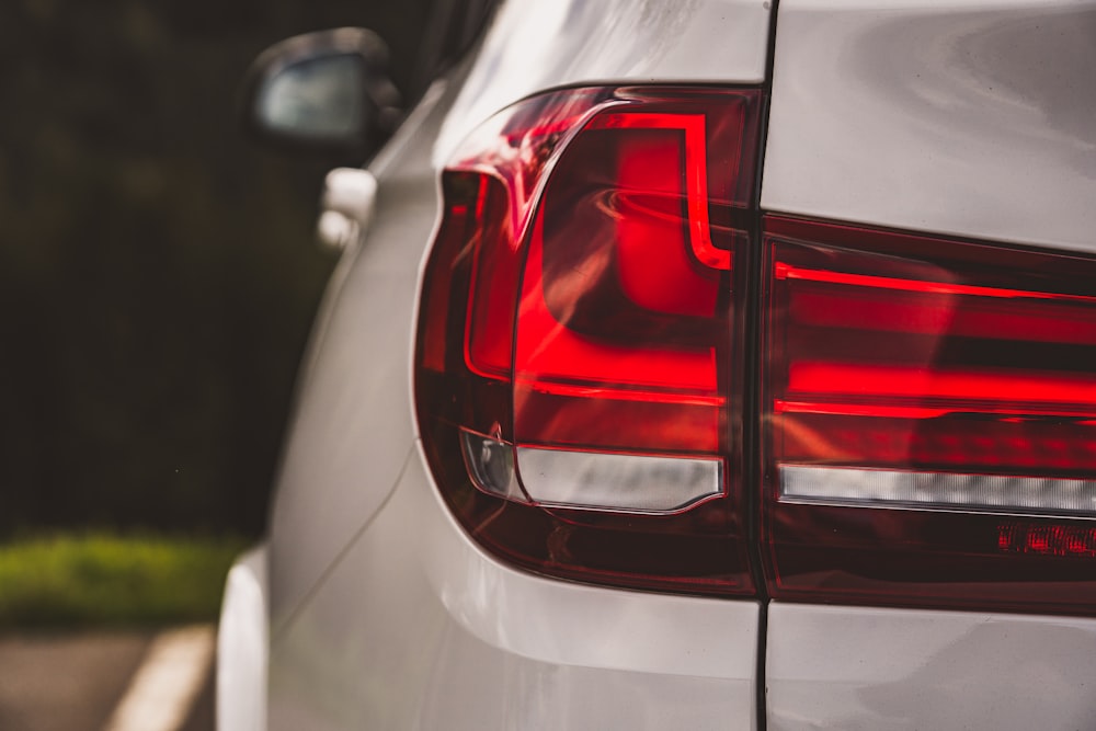 a close up of the tail lights of a white car