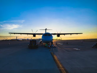 A Beechcraft Baron taxiing on a runway at sunset, ready for repositioning.