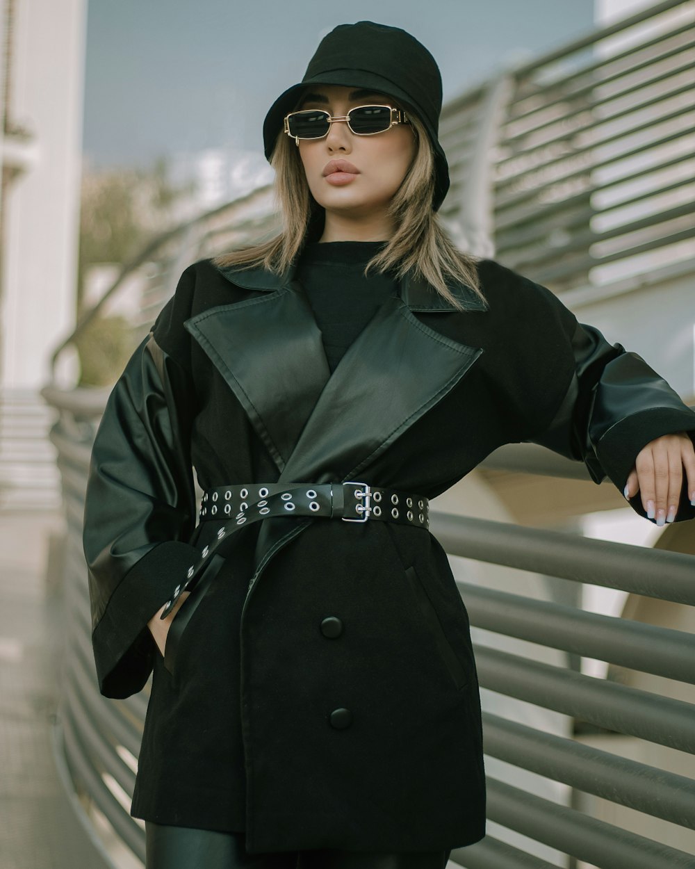 a woman wearing a black hat and a black coat