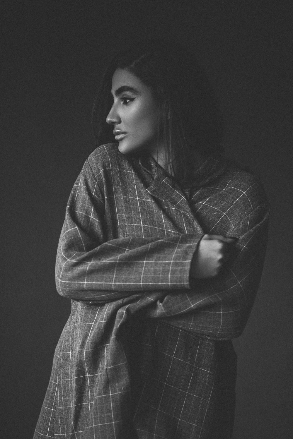 a black and white photo of a woman wrapped in a blanket