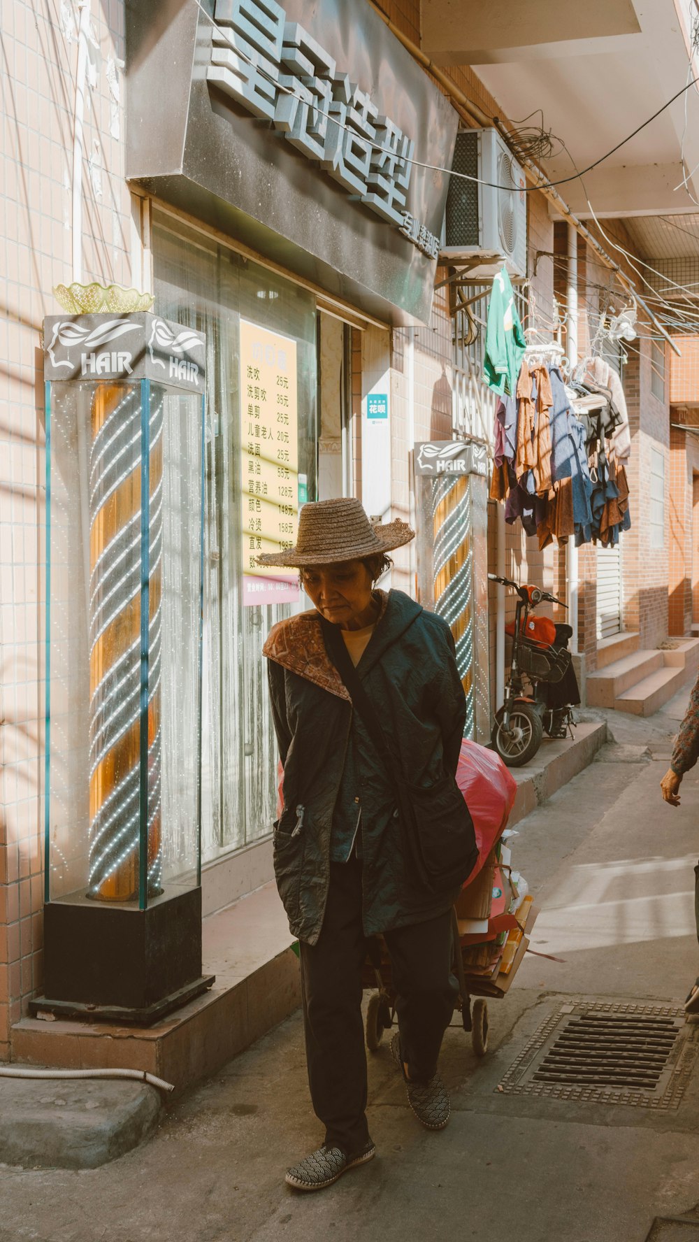 a man walking down a street next to a store