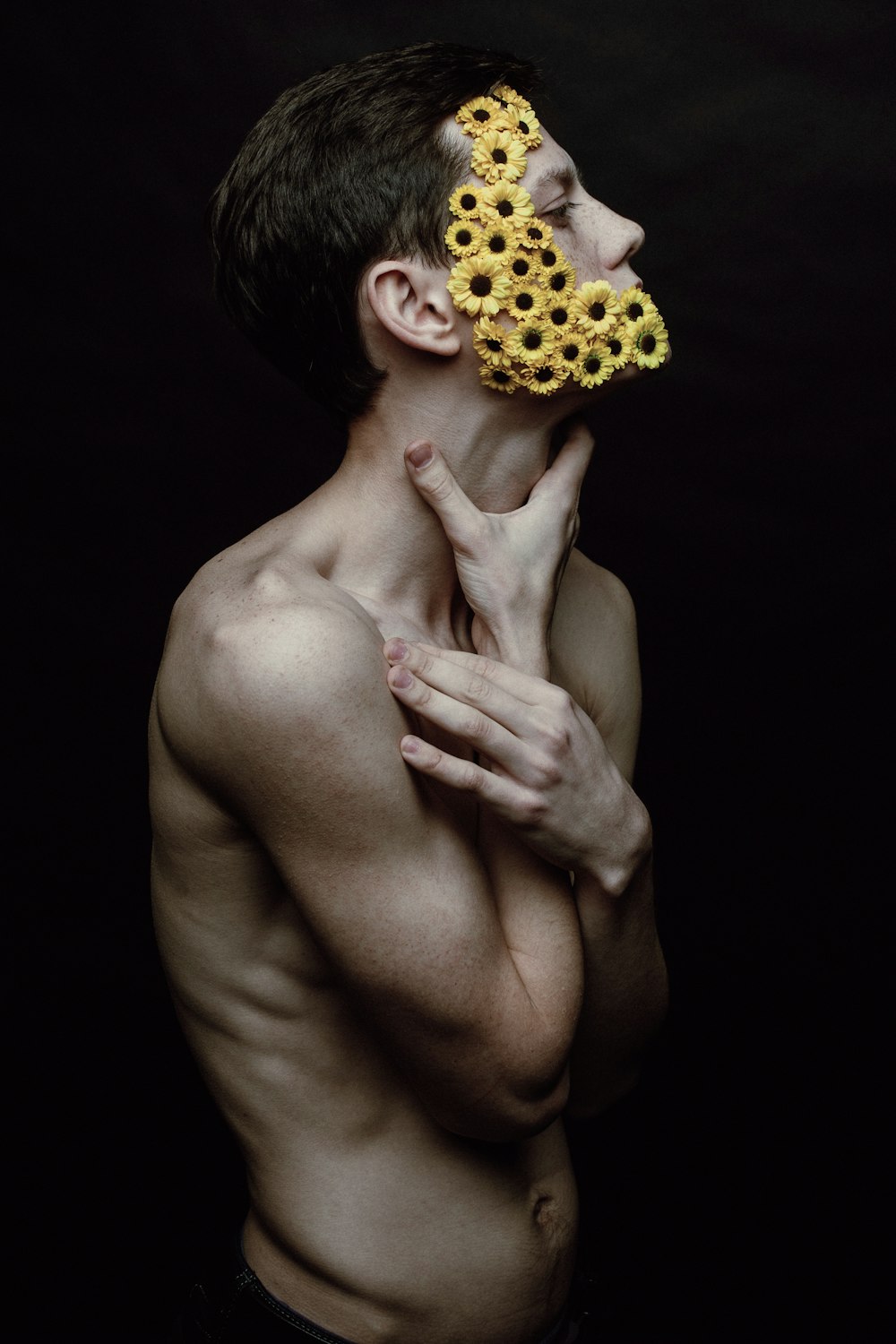 a man with a sunflower mask on his face