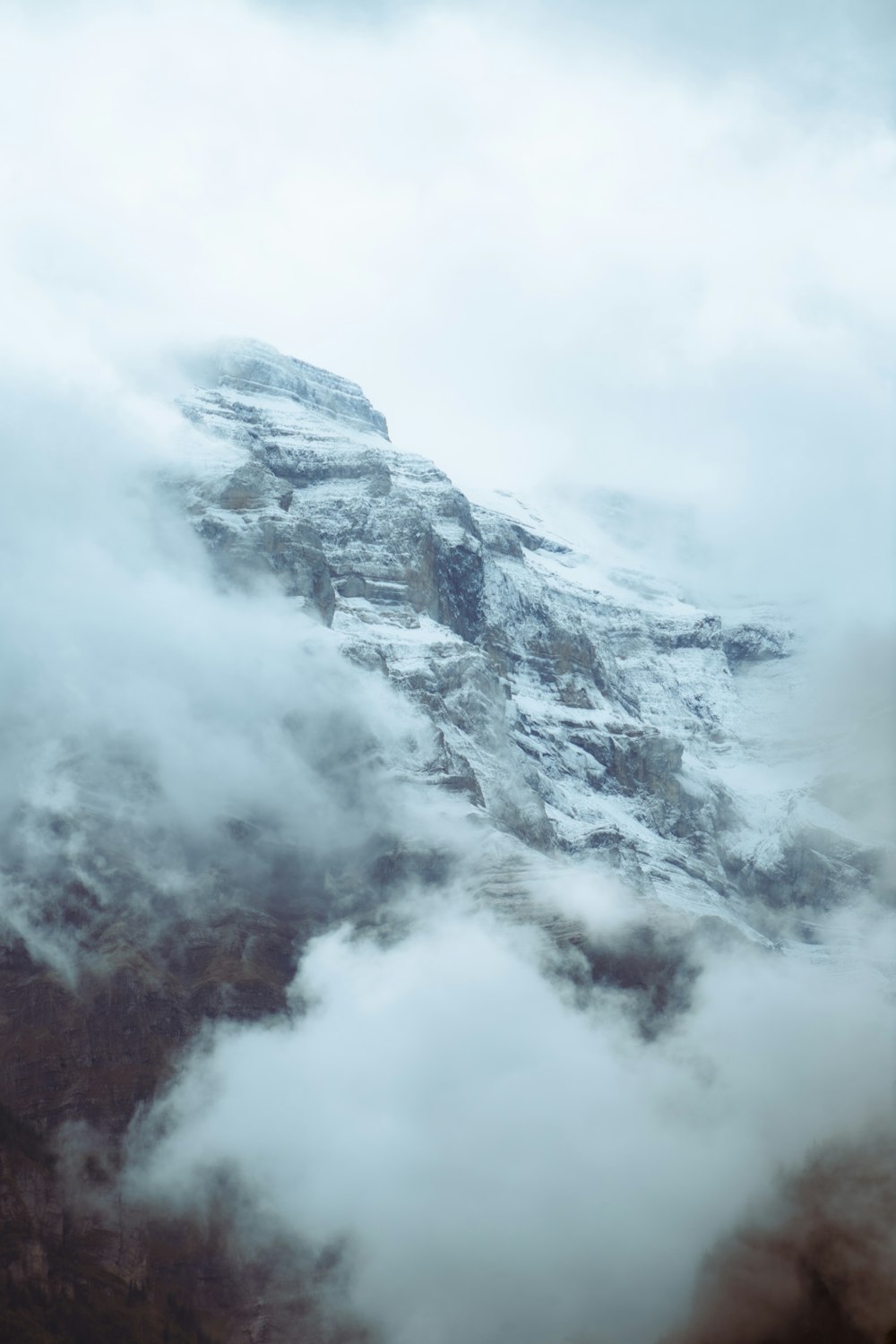 a view of a mountain covered in clouds