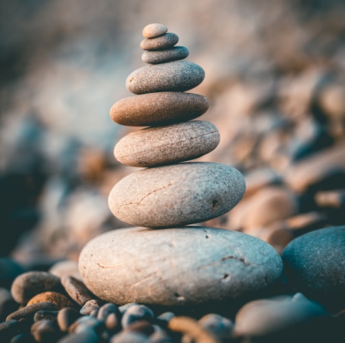 a stack of rocks sitting on top of a rocky beach