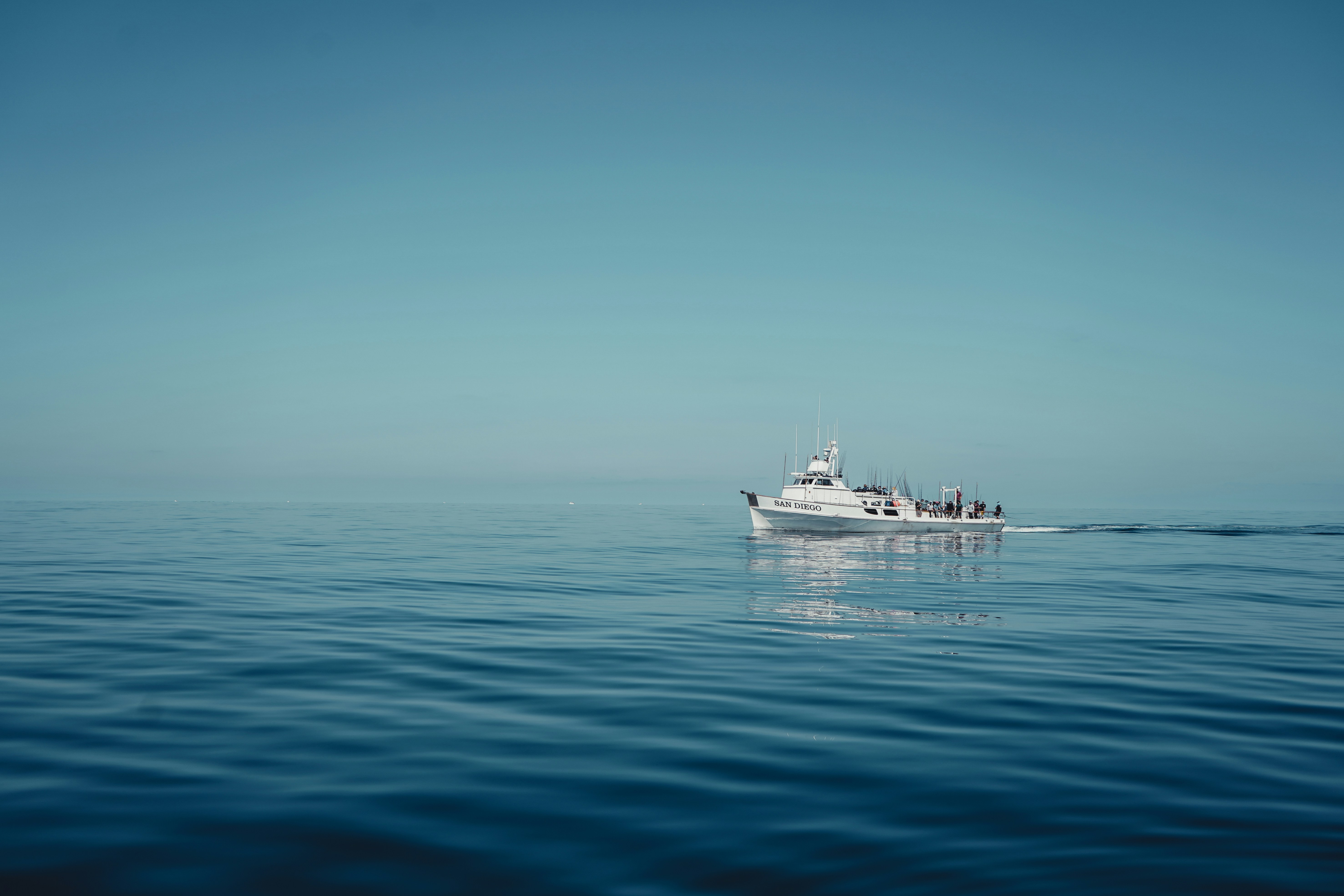 A white boat floating on top of a large body of water
