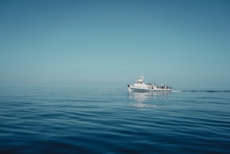 a white boat floating on top of a large body of water