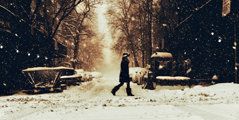 a person walking down a snow covered street