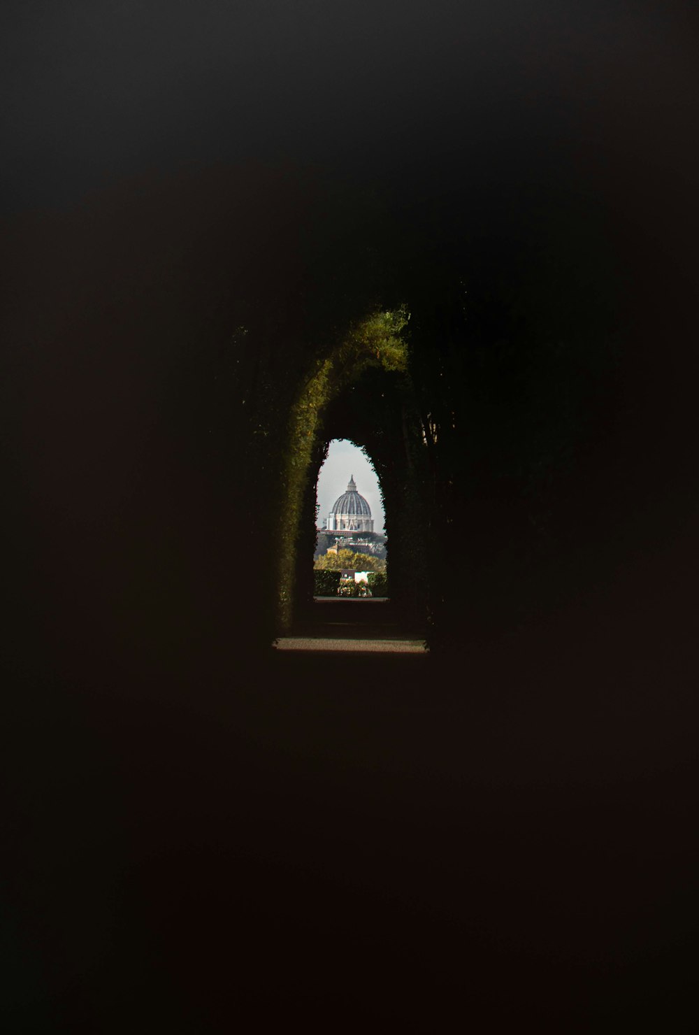 a view of a building through a tunnel