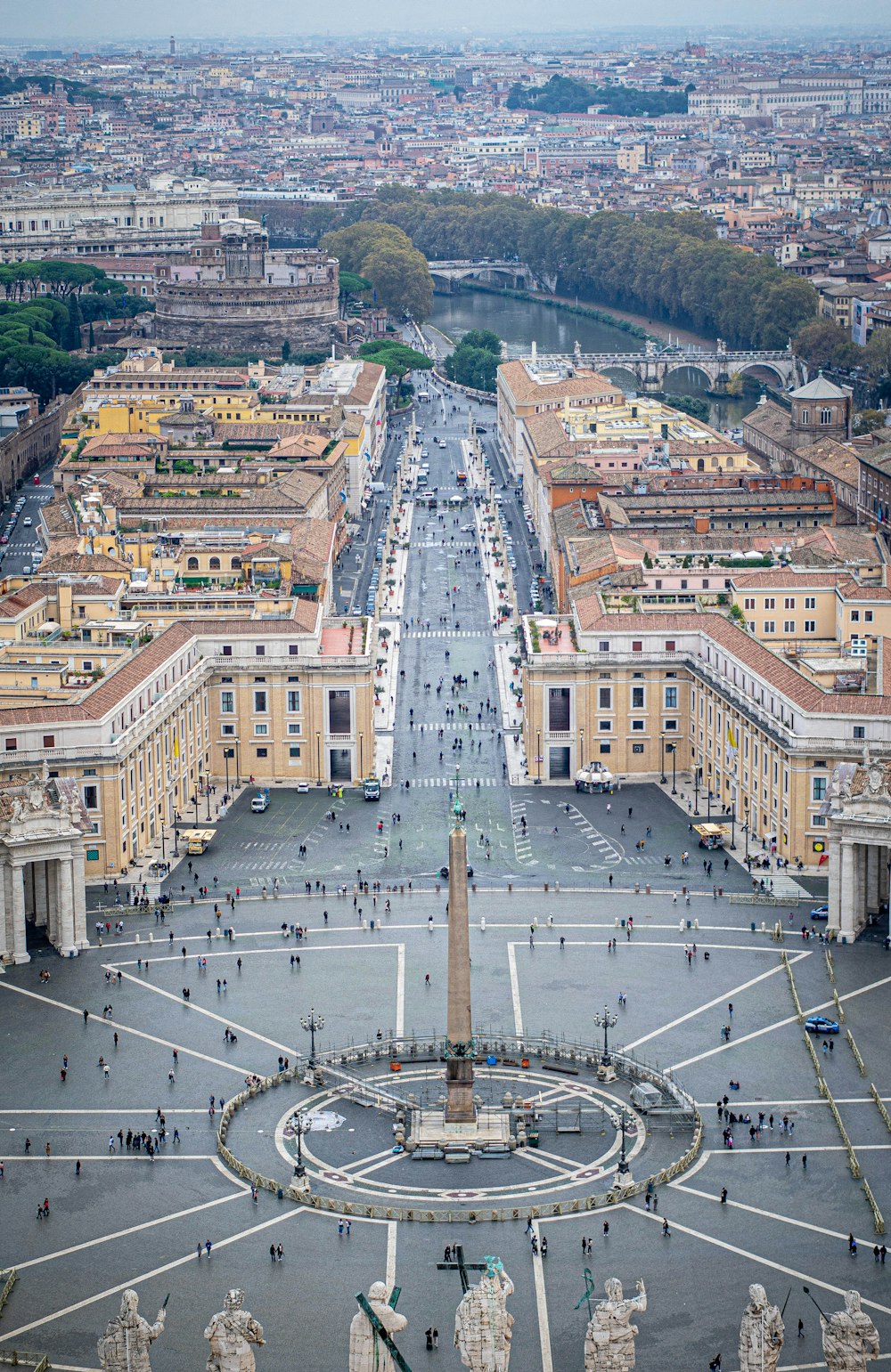 an aerial view of a city with a fountain in the middle