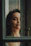 Soft natural light illuminating a calm, introspective woman in a cozy, minimalist room.