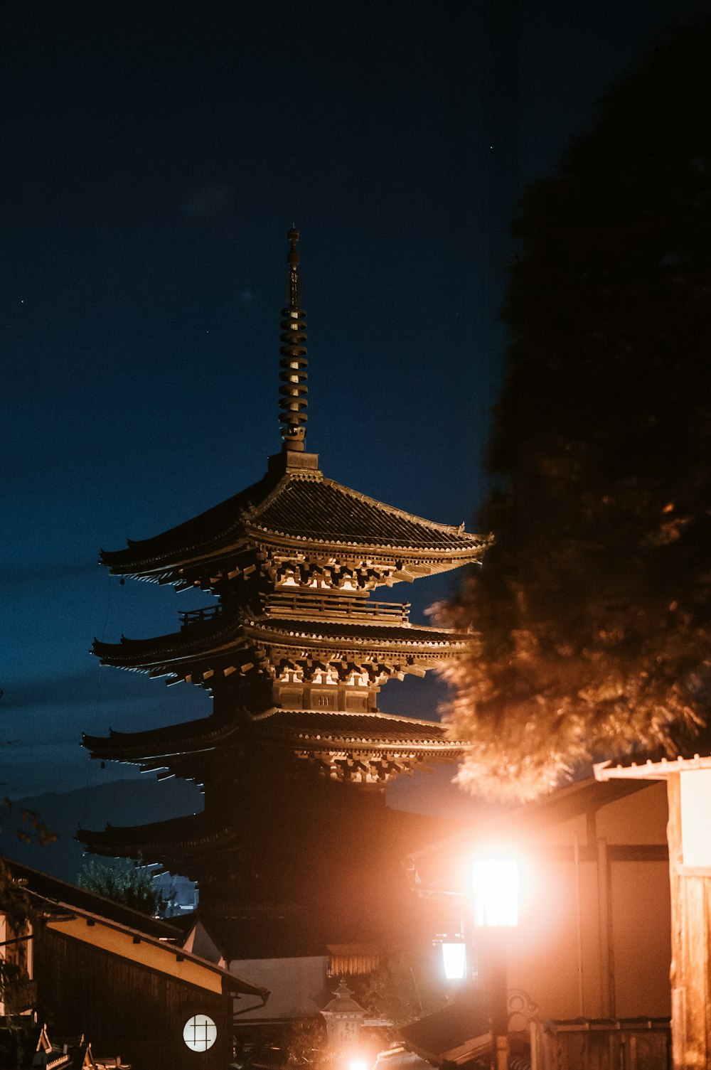 a tall building sitting next to a street at night