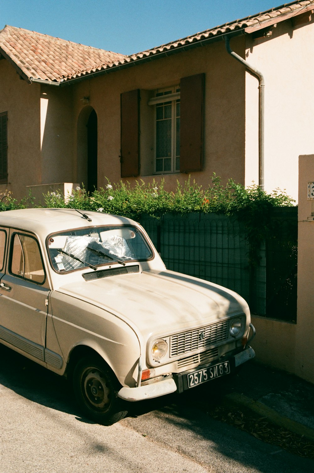 an old car parked in front of a house