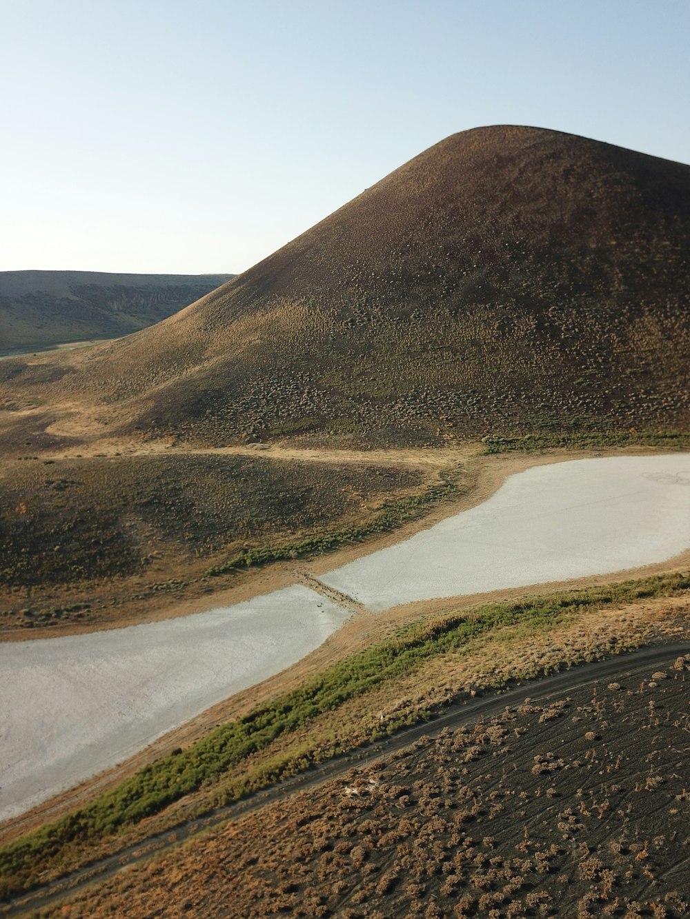 a hill with a lake in the middle of it