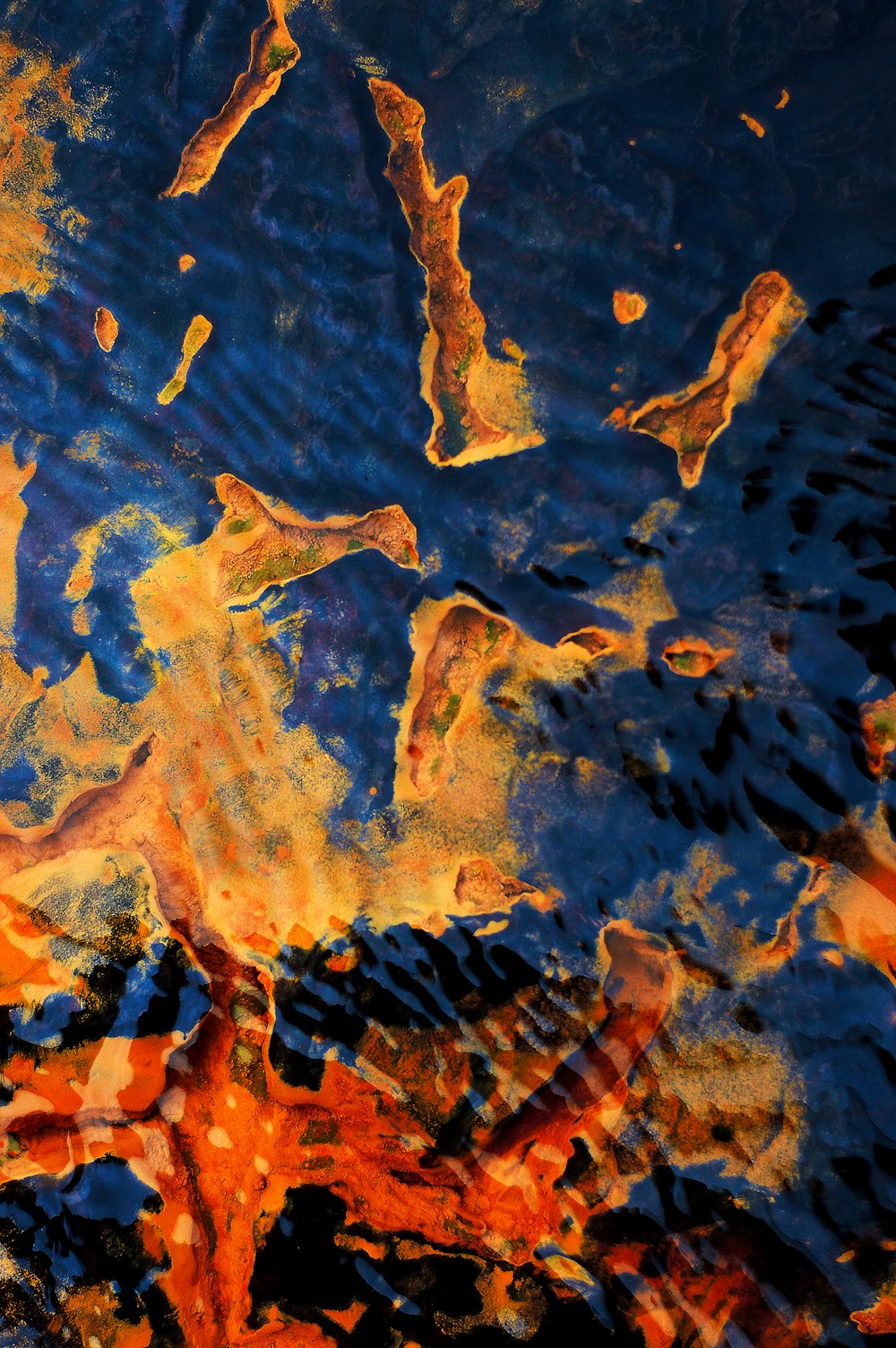an abstract painting of orange and blue colors
