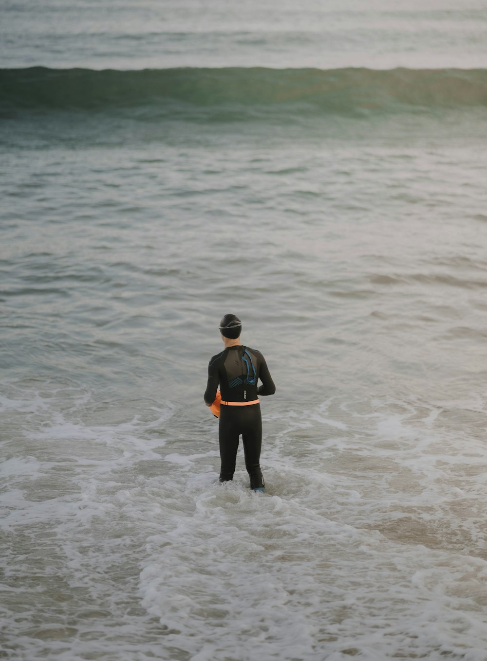 a man standing next to a body of water