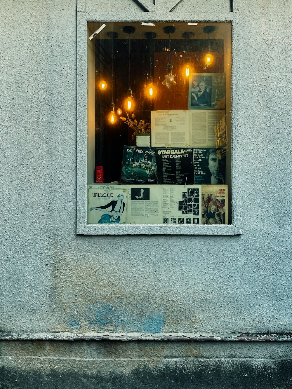 a window that has a bunch of posters in it