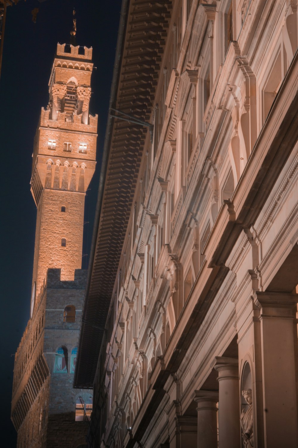 a tall clock tower towering over a city at night