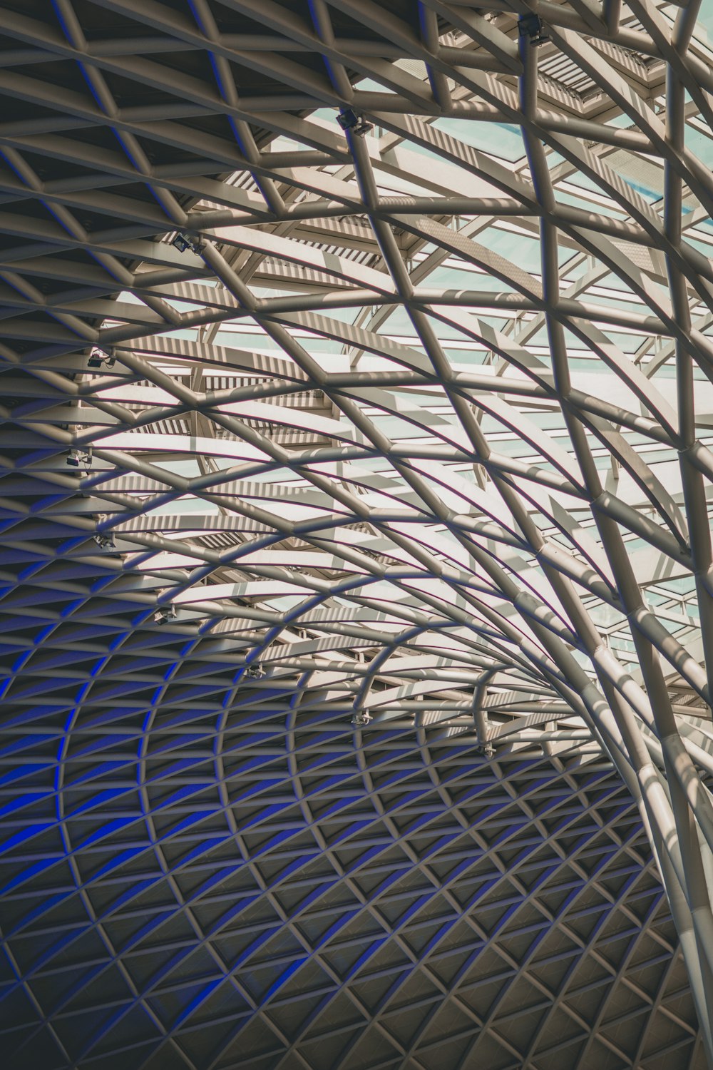 the ceiling of a building with a clock on it