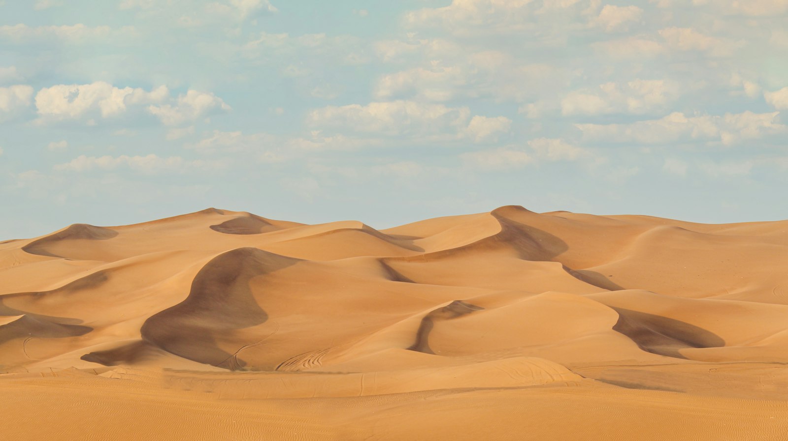 Rippled red-gold sand dunes in the desert outside Dubai