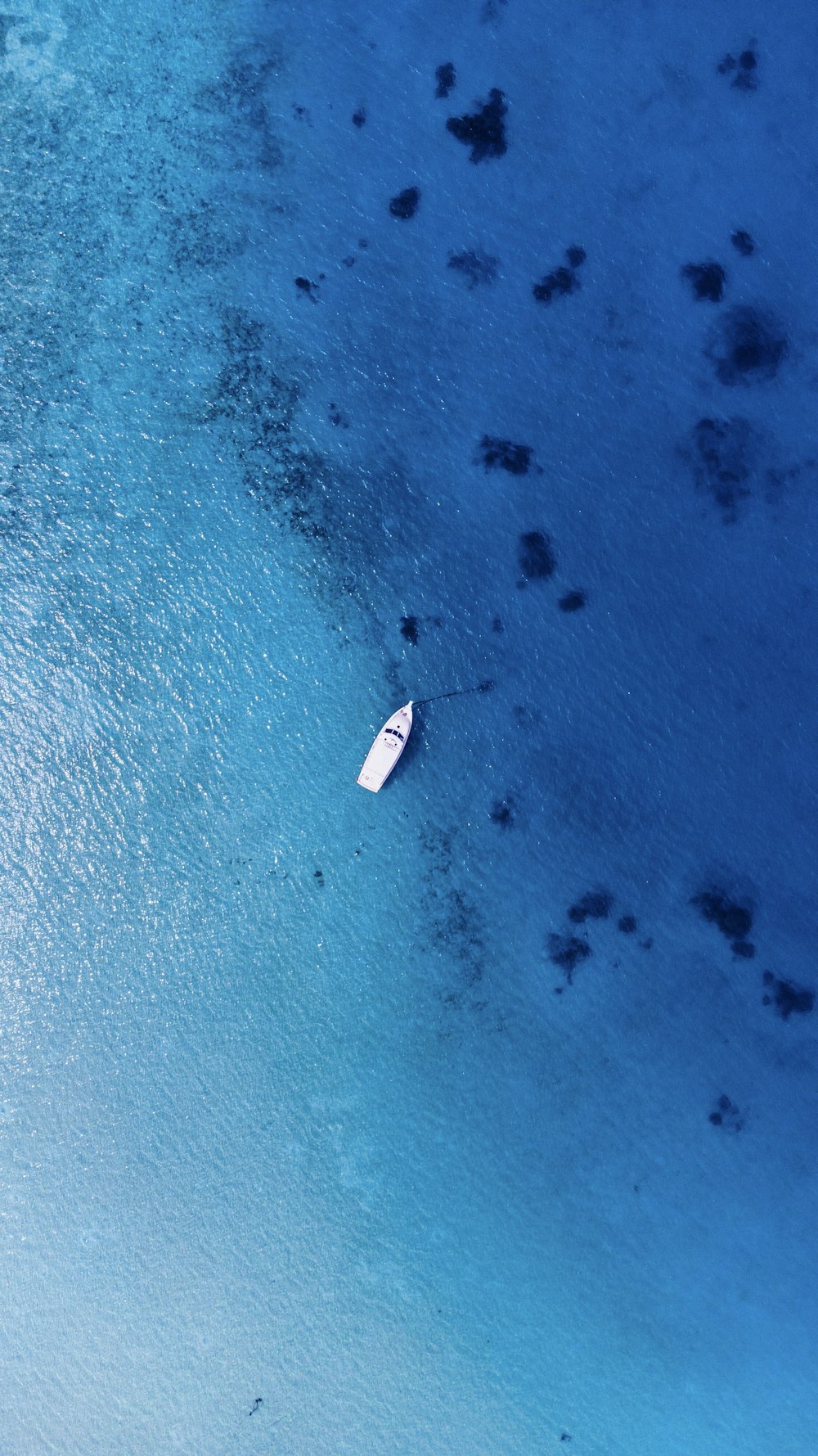 an aerial view of a boat in the water